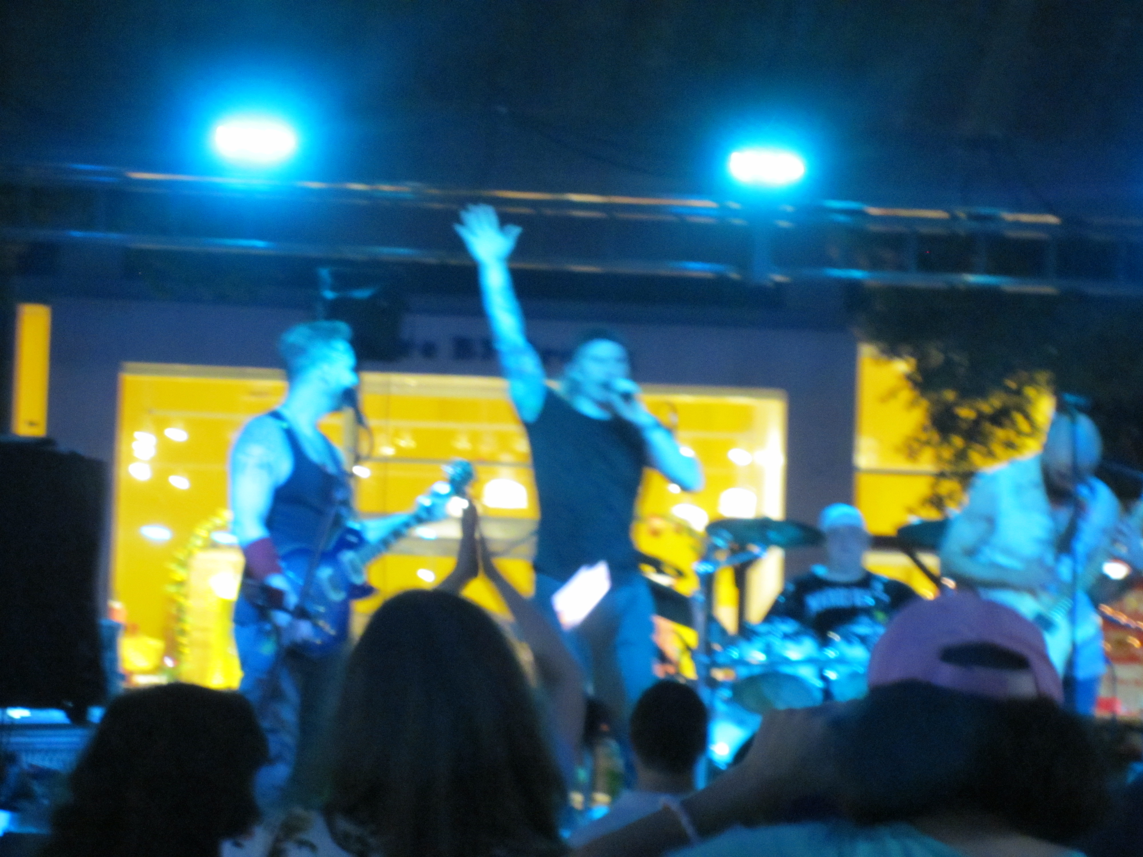 tunnel's end band performing onstage under blue and yellow stage lights